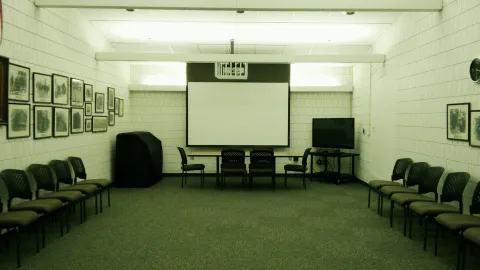 Meeting room with large screen and chairs